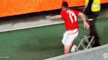 a soccer player wearing a red shirt with the number 17 on it