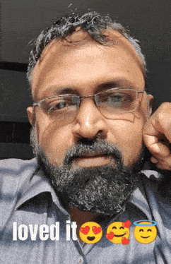 a man with glasses and a beard has the words loved it below him