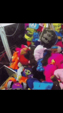 a bunch of stuffed animals including a gorilla with a peace sign on it