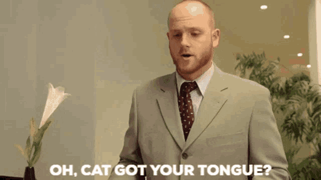 a man in a suit and tie is saying " well cook that cat in a salty broth "