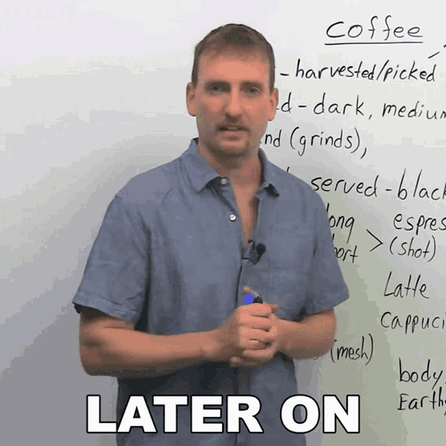 a man stands in front of a whiteboard with the words coffee written on it