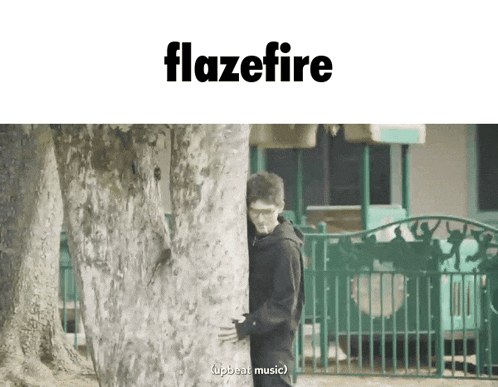 a man standing behind a tree with the word flazefire on the top