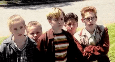 a group of young boys are standing in a line with their arms crossed