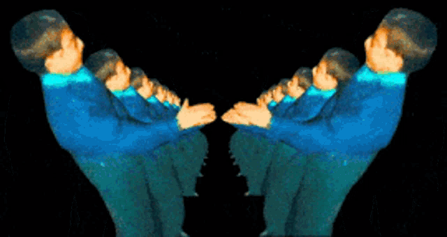a group of people in blue shirts are standing next to each other on a black background