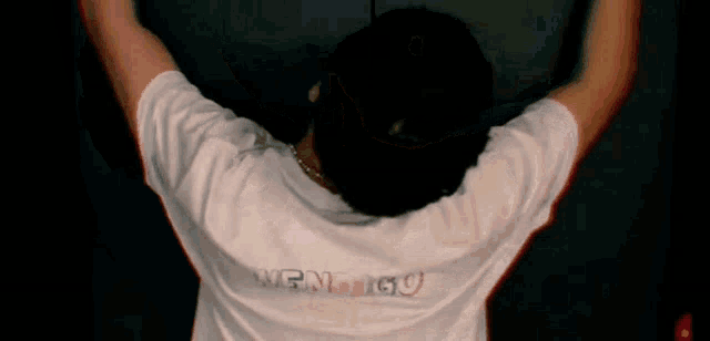 a person wearing a white shirt with the word energy on the back of it