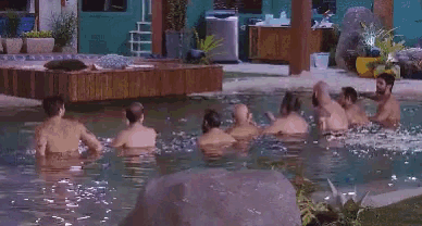 a person is swimming in a pool with a large eye in the water