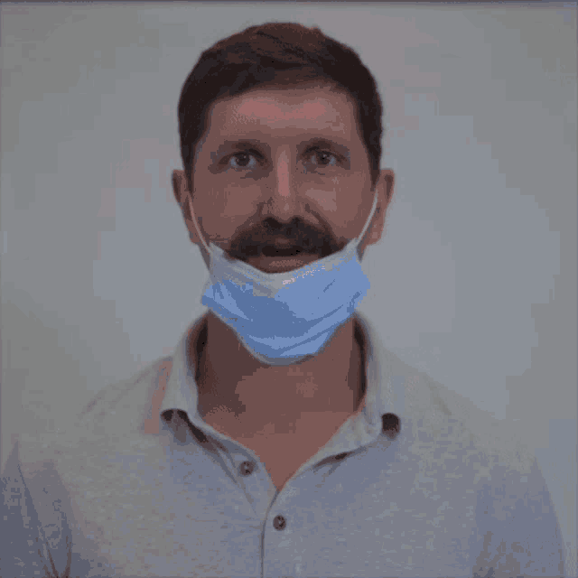 a man wearing a face mask with the word cute on the bottom