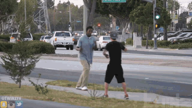 two men standing on a sidewalk in front of a street sign that says carl smith pkwy