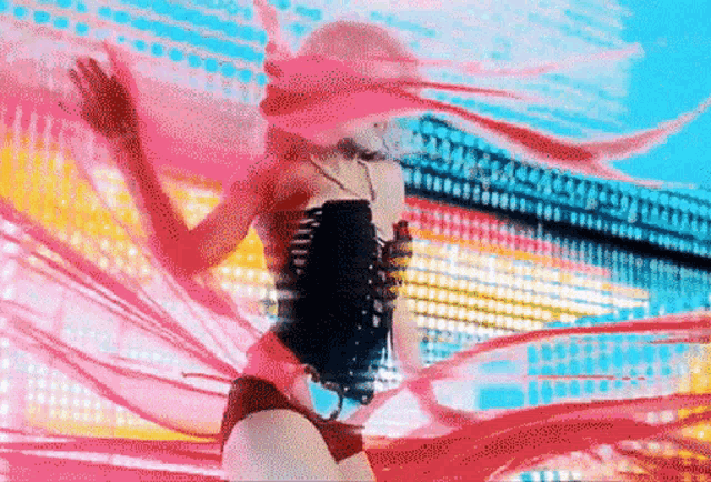 a woman in a swimsuit is dancing in front of a colorful backdrop