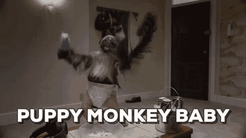a person dressed as a baby monkey is dancing in a room .