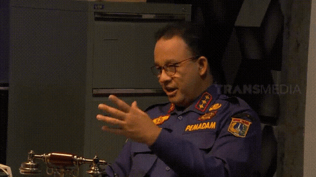 a man in a blue uniform with the name pemadam on his sleeve
