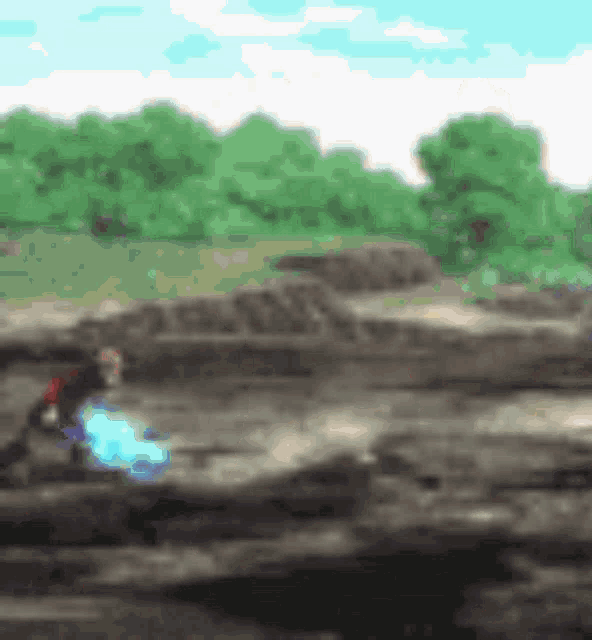 a blurry picture of a person holding a blue object in a field .