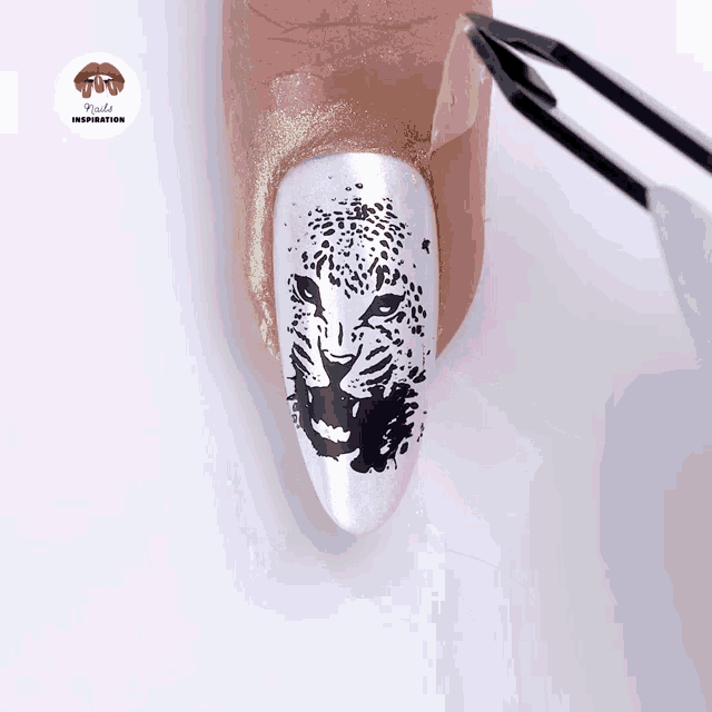 a close up of a nail with a picture of a leopard and the words nails inspiration