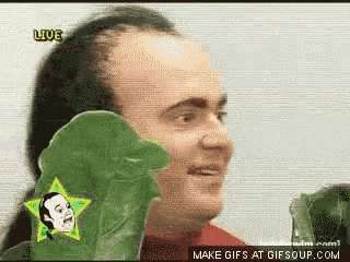 a man in a red shirt is holding a green glove with a star on it