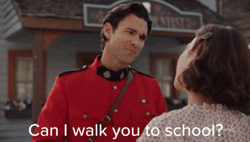 a man in a red uniform is talking to a woman in front of a building that says dentists