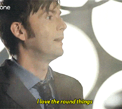 a man in a suit and tie is saying " i love the round things "