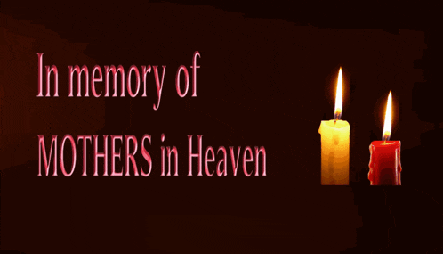 two lit candles with the words in memory of mothers in heaven behind them