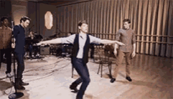 a man is dancing in front of a group of people
