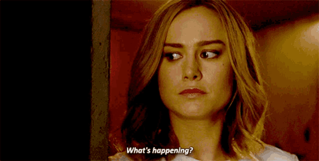 a close up of a woman 's face with the words `` what 's happening '' written on her face .