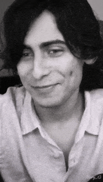 a black and white photo of a young man with the name mary 13 on the bottom right