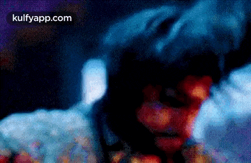 a blurry picture of a person in a hood with smoke coming out of it .