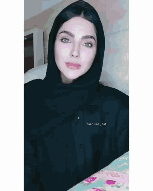 a woman wearing a black shirt with the name hadise_hdi on the front
