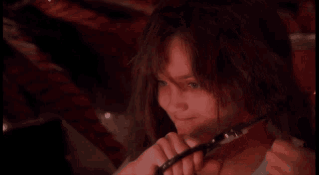 a woman is holding a pair of scissors in her hand
