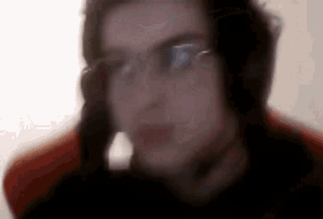 a blurry picture of a person wearing headphones and a headset .