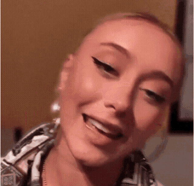 a close up of a woman 's face with her mouth open and a smile on her face .