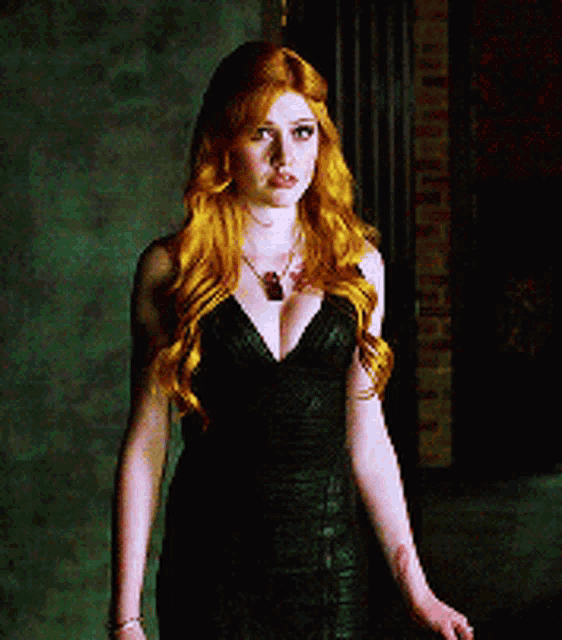 a woman with red hair wearing a black dress and necklace