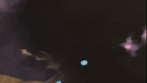 a blurry picture of a purple light and a white light