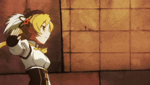 a yellow haired anime girl is standing in front of a wall holding a sword .