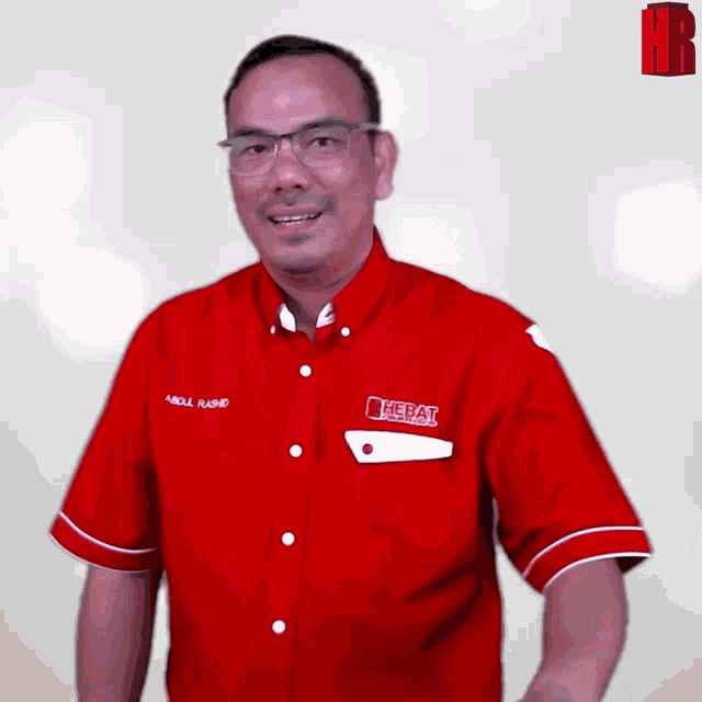 a man wearing a red shirt with the word herat on the front