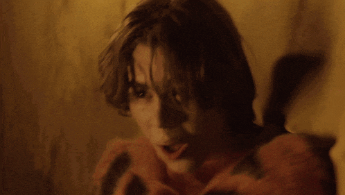 a blurry picture of a person 's face against a wall
