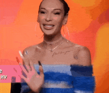 a woman with a tattoo on her chest is wearing a blue and white striped top and earrings .