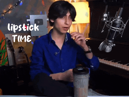 a man sitting in front of a microphone with the words lipstick time written on the bottom