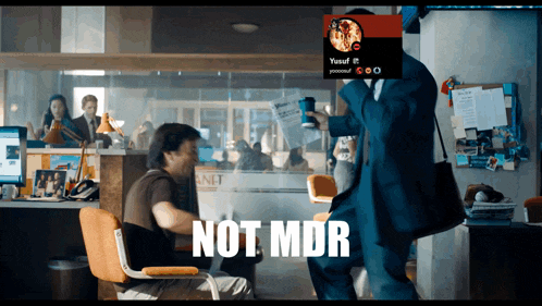 a man in a suit is standing next to a man in a chair with the words not mdr on the bottom