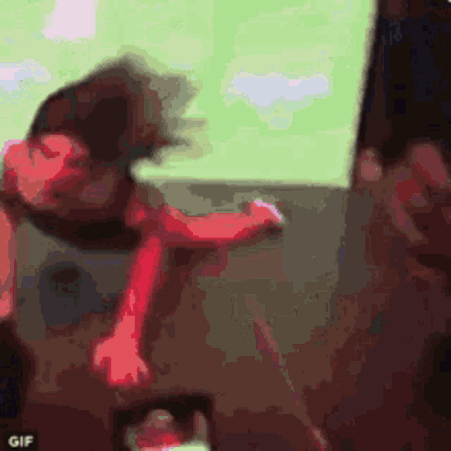a blurry picture of a person laying on a couch with their head on the floor .