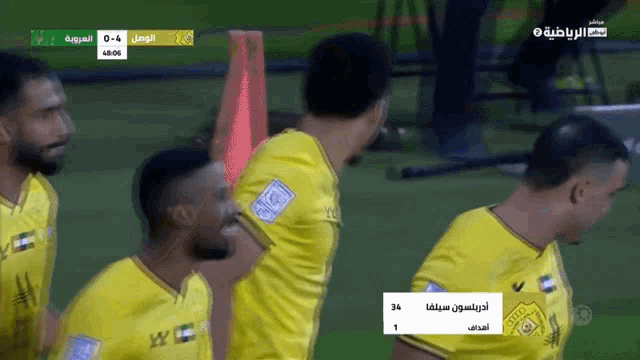 a group of soccer players are celebrating a goal with a scoreboard that says 34