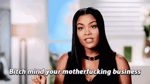 a woman is pointing at the camera and saying `` bitch mind your mother fucking business '' .