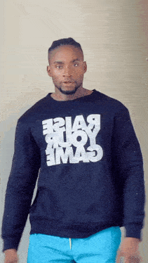 a man wearing a black sweatshirt that says ' e2ia9 ' on it