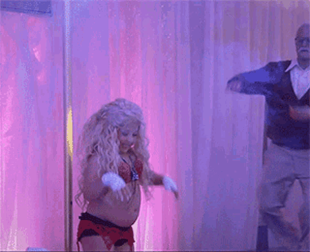 a man is throwing money at a woman who is dancing
