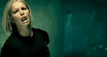 a woman is screaming in a dark room .