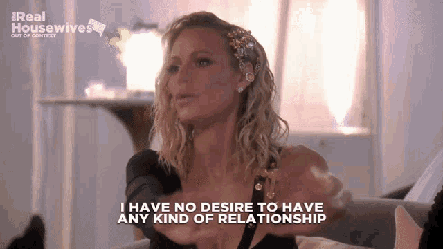 a woman sitting on a couch with the words i have no desire to have any kind of relationship above her