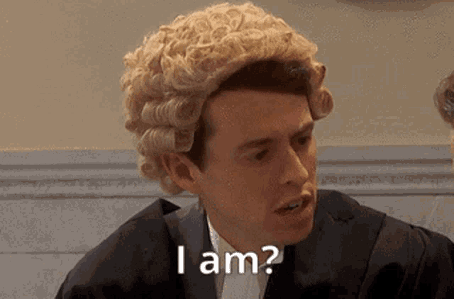 a man wearing a wig and a suit says i am