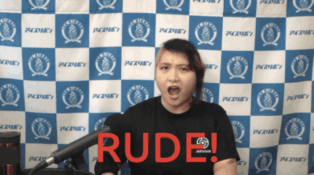 a woman stands in front of a blue and white checkered backdrop with the word rude written in red
