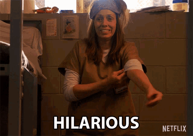 a woman in a prison uniform says hilarious on the screen