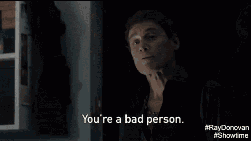 a man in a suit says " yeah well you were a fat baby " in a dark room