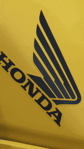 a yellow honda logo with a blue wing on it