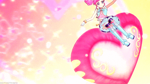 a girl with pink hair is sitting on a heart shaped object